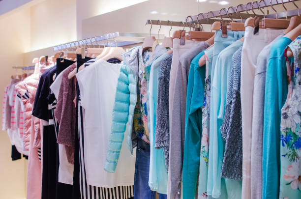 istock Women clothes on racks in a fancy store. 664712030