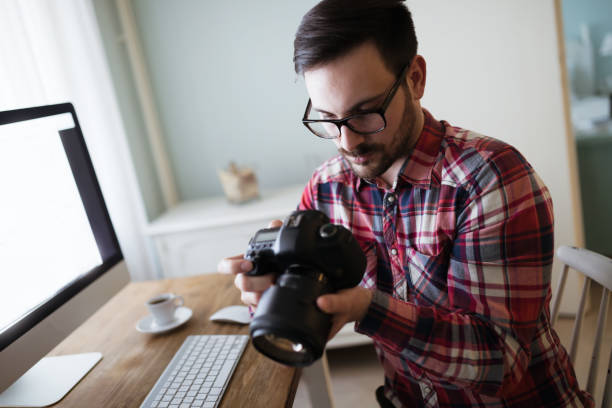 istock Photographer retouching working on photos and editing on desktop 664712048