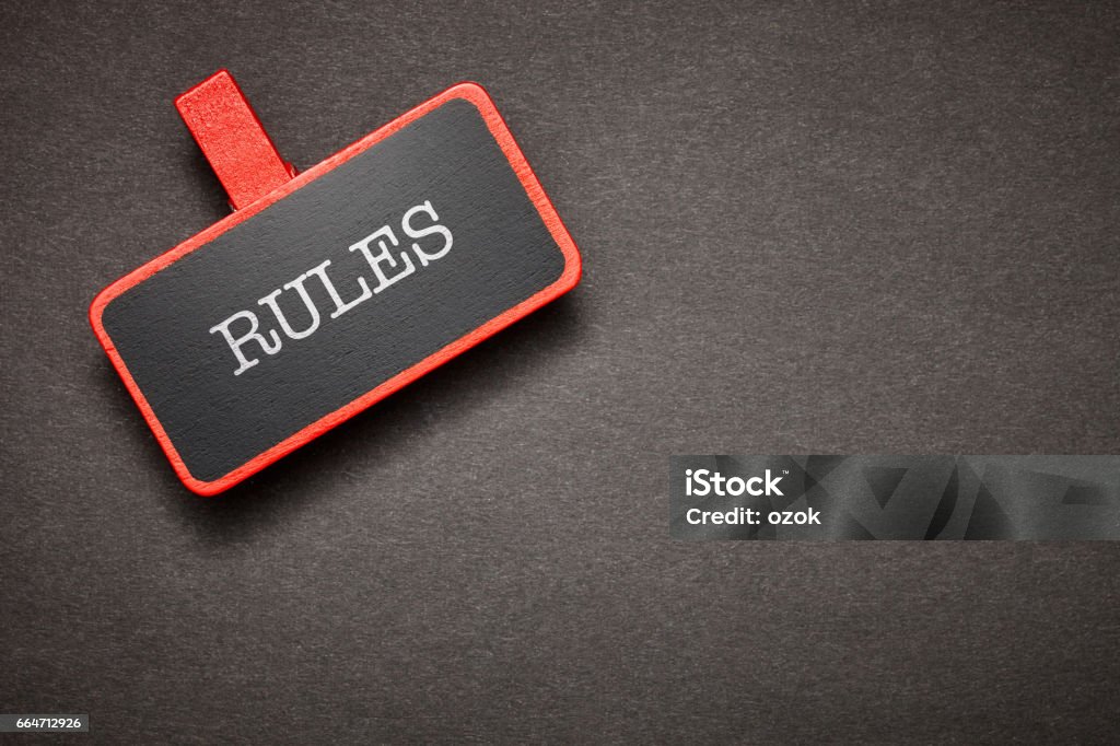 red label on the chalkboard Rules Stock Photo