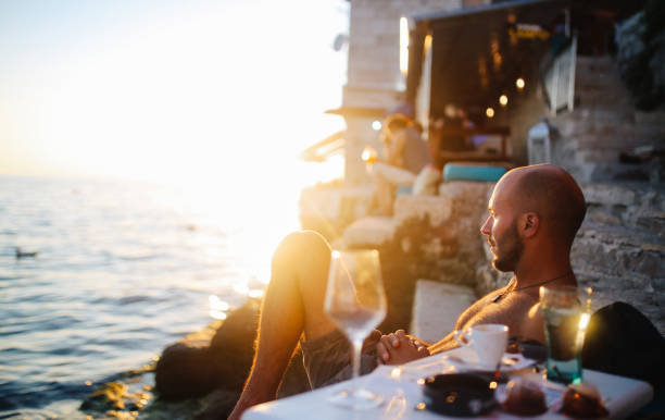 Young man enjoying the summertime by the sea