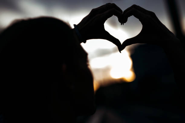 istock Silhouette of a heart made by hand 664715890