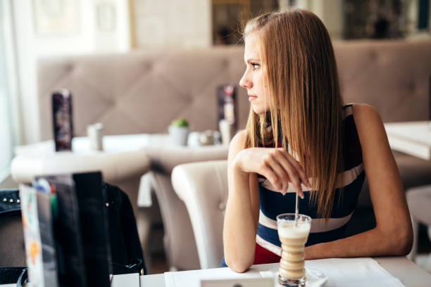 istock Beautiful woman enjoying her coffee in restaurant 664716246