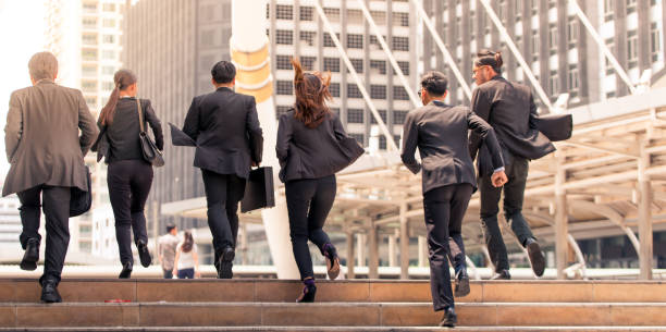istock Business people running in city 664723516