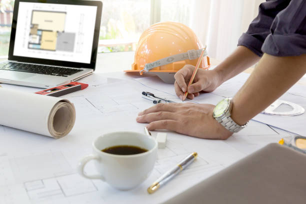 istock Interior designer discussing data and digital tablet and computer laptop with business document and graphics design diagram on wooden desk as concept 664723772