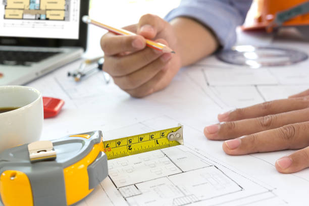 istock Interior designer discussing data and digital tablet and computer laptop with business document and graphics design diagram on wooden desk as concept 664723780