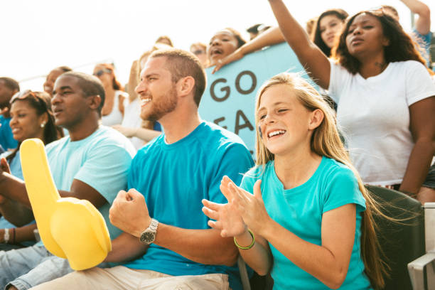 istock Crowd of fans cheering from stadium bleachers 664727940