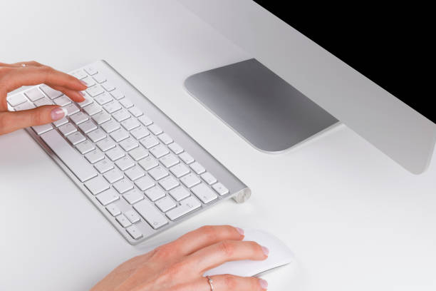 istock close up of businesswoman hand using computer with wireless mouse and keyboard 664728058