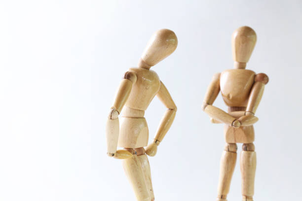 istock Wooden doll posing trouble on white background 664731500