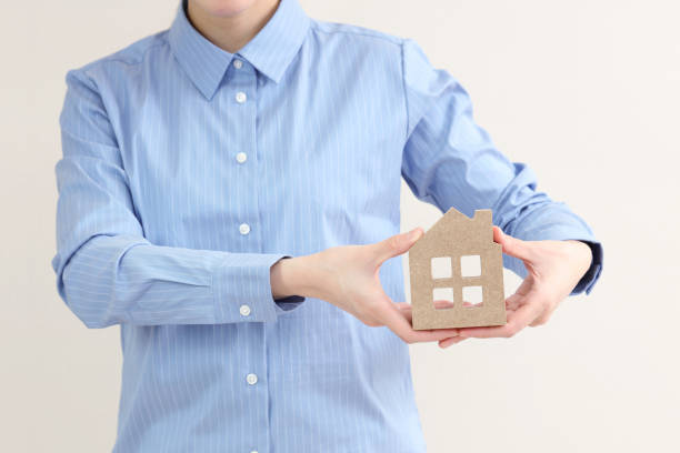 istock hand holding a wood house 664732496