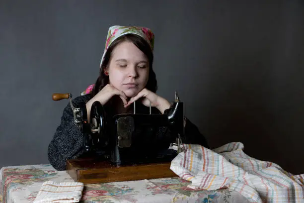 Photo of a girl at an old sewing machine