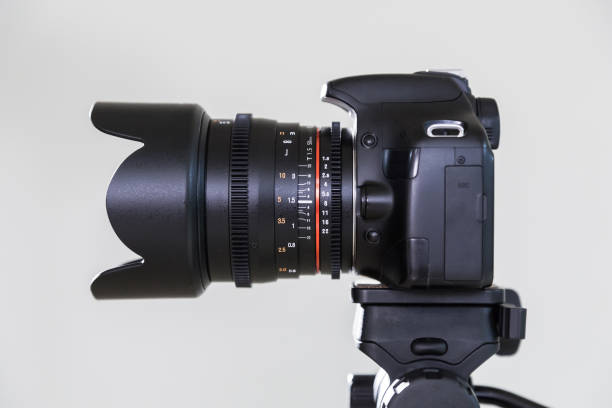istock Digital SLR camera with interchangeable manual lens on a gray background. Shooting in the interior. The equipment for filmmaking 664735142