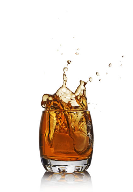 istock Splash in glass of scotch whiskey with ice cube 664738254