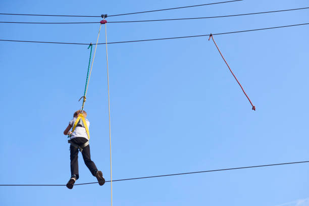 istock Cute school boy enjoying a sunny day in a climbing adventure activity park. 664738852