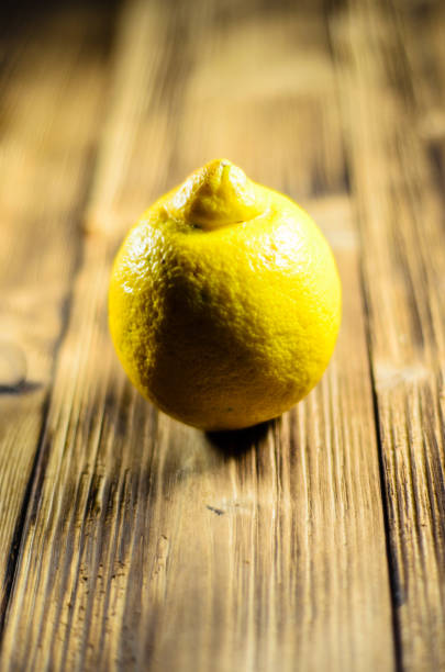 istock Yellow lemon on wooden table 664742588