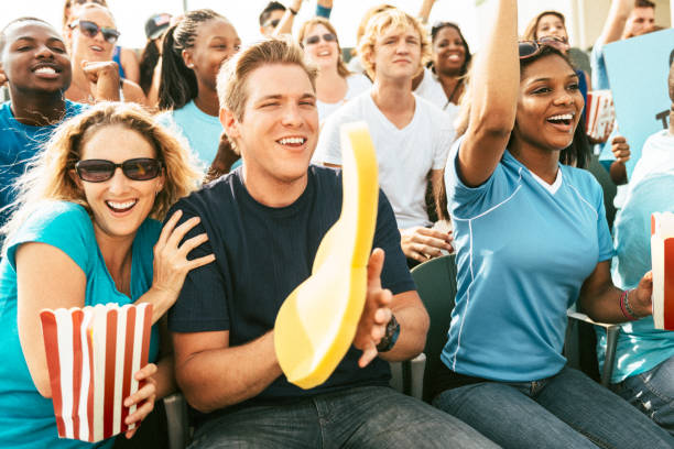 istock Crowd of fans cheering from stadium bleachers 664742680