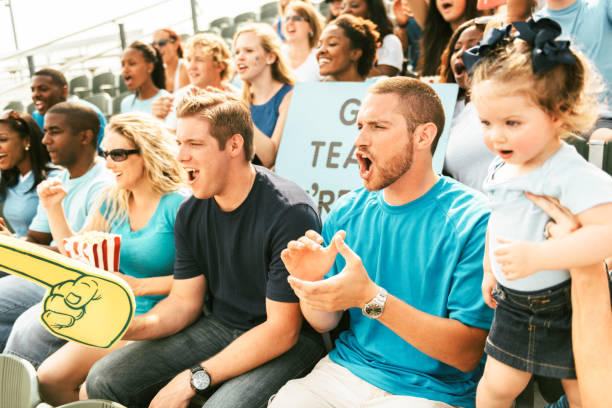 istock Crowd of fans cheering from stadium bleachers 664749270