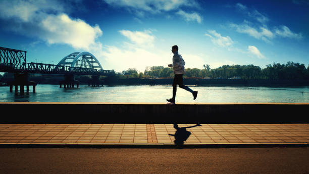 istock Jogging in the morning by the river. 664753338