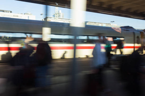 istock trainstation with symbols and travellers 664758338