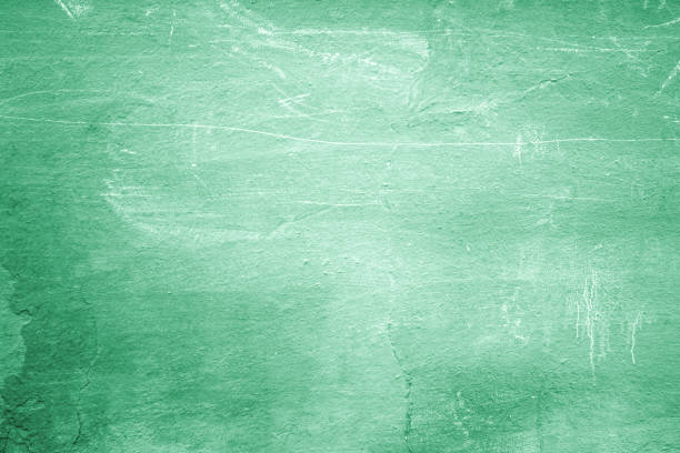istock Green cement wall concrete texture close-up as background for design 664761390