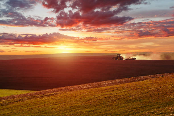 istock Farmer in tractor preparing land with seedbed cultivator over Blurred construction site.CSR ESG Business on industry, People, Science,Signs, Symbols, Technology, Transportation concept 664762666