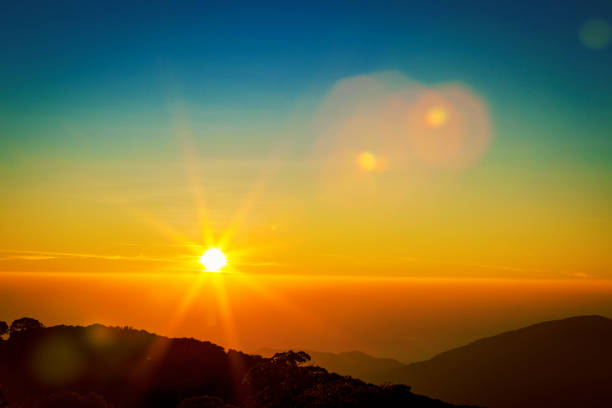 istock Golden sunrise or sunset sky with sun flare on the mountains. 664772034
