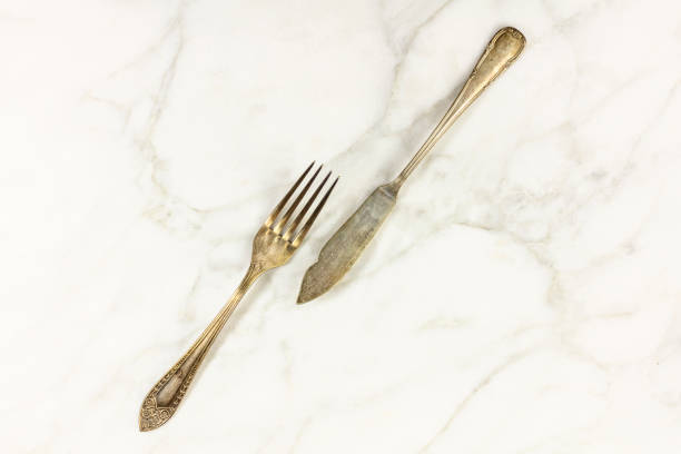 istock Vintage fork and knife on white marble with copyspace 664775938