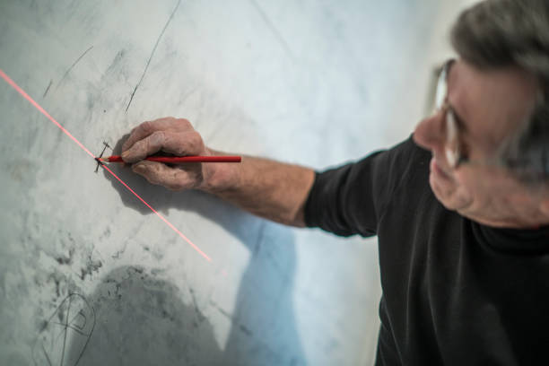 istock 70-years-old active senior man, construction worker - plumber, doing measurments 664776016