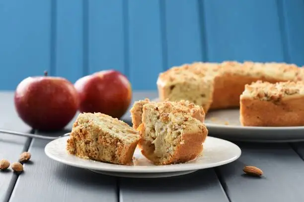 Homemade appetizing wholegrain almond cake with fresh red apples with copyspace