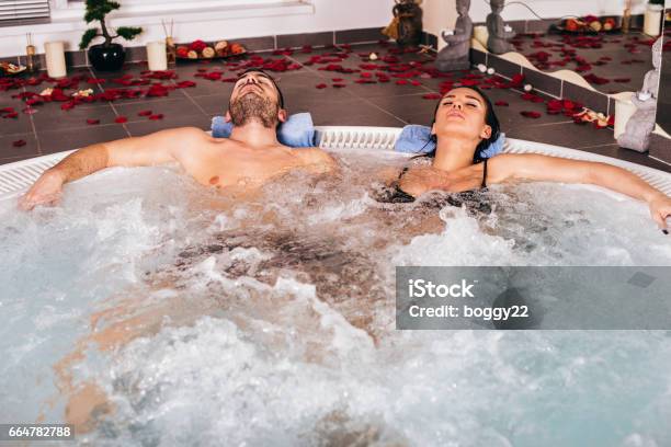 Young Attractive Couple Relax In Hot Tub Stock Photo - Download Image Now - Adult, Adults Only, Bathtub