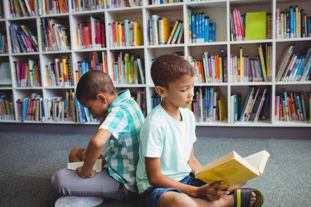istock Little boys reading books 664783146