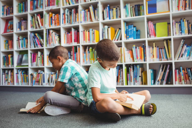 istock Little boys reading books 664783350