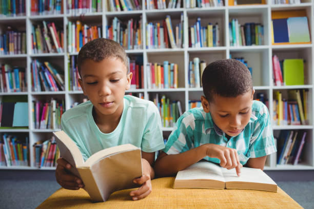 istock Little boys reading books 664790100