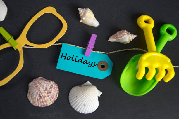 istock Holidays  inscription written on paper tag 664800734