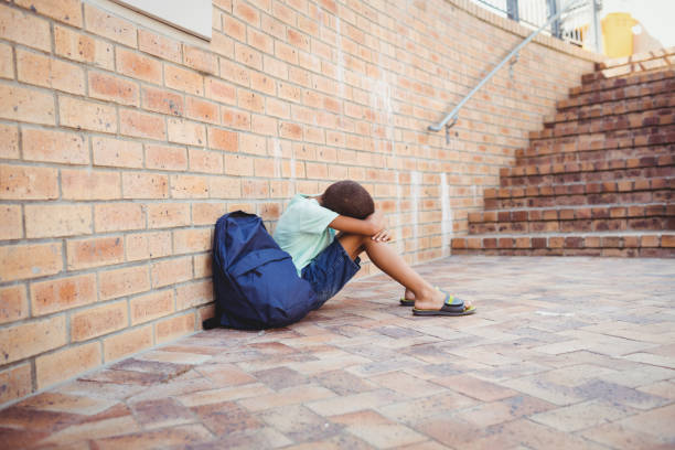 istock Sad boy with his head on his knees 664803854