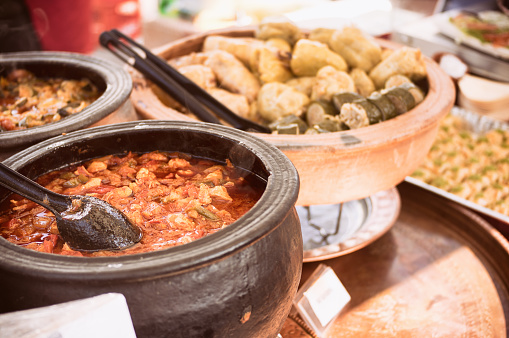 Photo of oriental pots with food at open food market can be used ofr any gourmet purposes, city lifestyle, open market and streed food