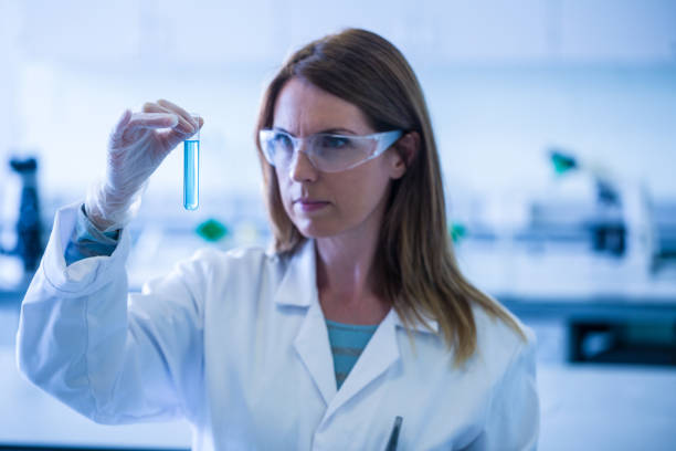 istock Scientist looking at test tube in the laboratory 664807666