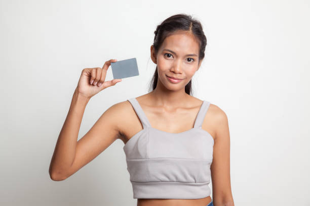 istock Young Asian woman smile with blank card. 664811582