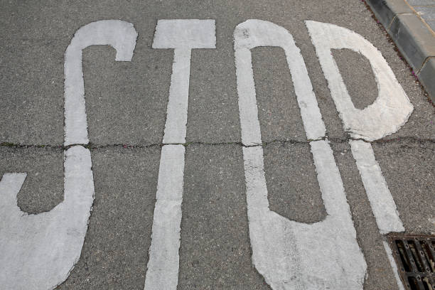 istock stop sign painted on the road 664811702