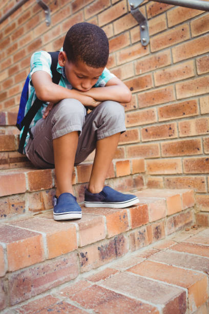 istock Sad schoolboy with his head on his knee 664813872