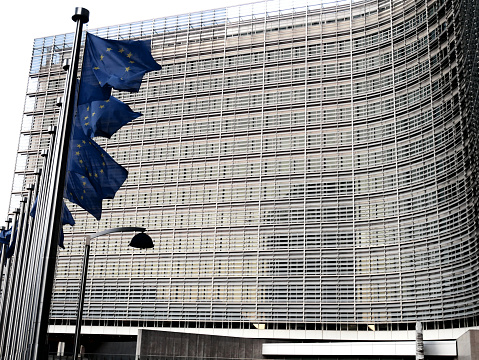 EU flags waving near the Berlaymont Building - European Commission in Brussels, Belgium