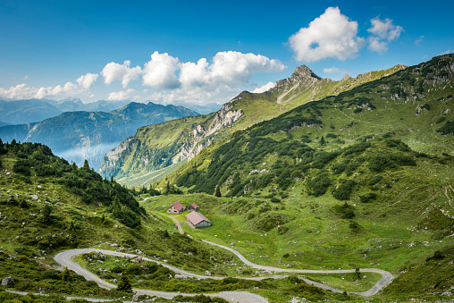 Landscape with a curvy country road in the mountains close to the Formarinsee in Vorarlberg, Austria