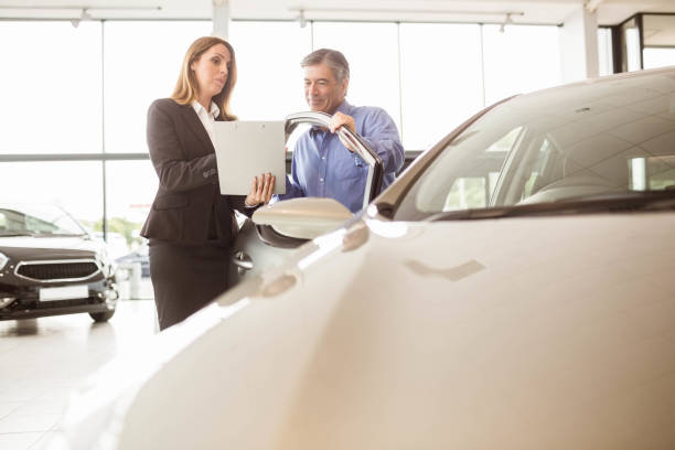 istock Smiling businesswoman undersign a car contract 664817872