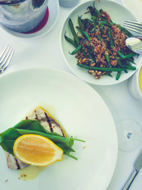 istock Swordfish on a plate with spinach and lemon. 664820660