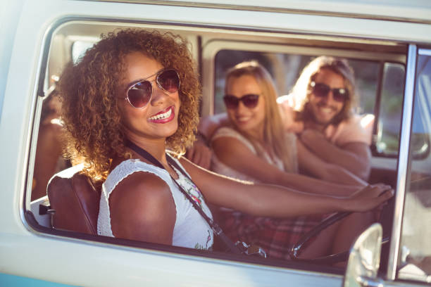 istock Happy woman driving a campervan 664827180