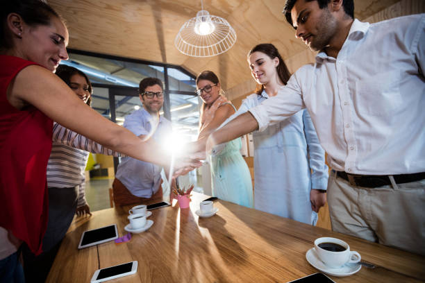 istock Casual colleagues putting hands together 664831922