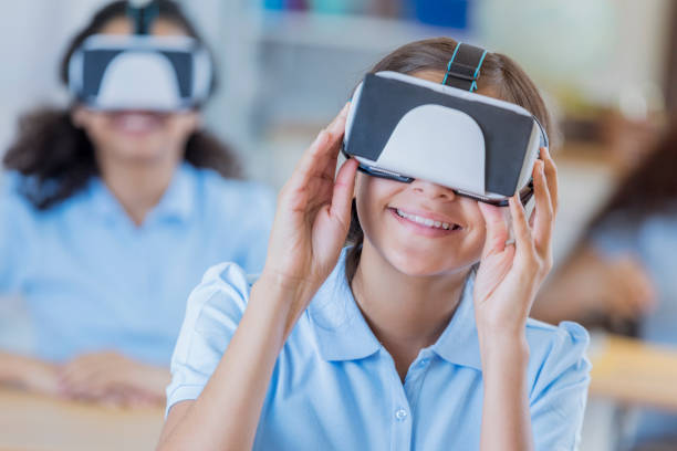 istock Female student uses virtual reality goggles in the classroom 664838284