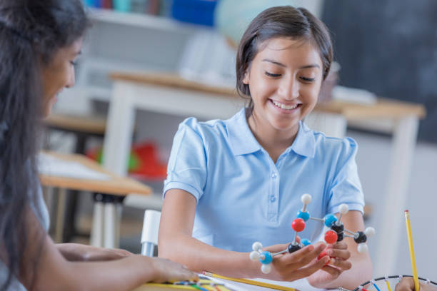 istock Cheerful girl in science class 664838306