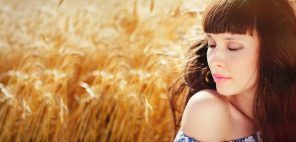 istock A field of wheat. Beautiful woman 664838974