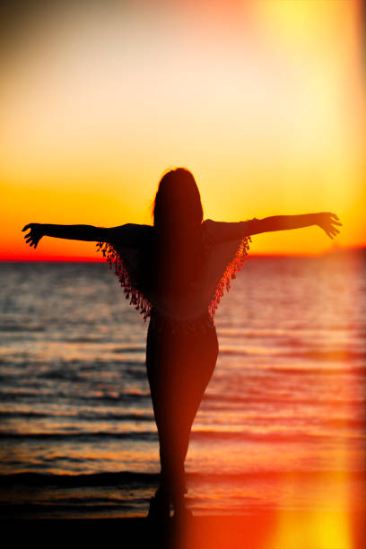 istock Young woman open arms at sunset 664842876
