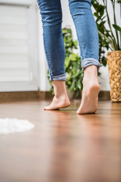 Warm floor - the concept of floor heating and wooden panels. Floor heating. Young woman walking in the house on the warm floor. Gently walked the wooden panels. heat home interior comfortable human foot stock pictures, royalty-free photos & images